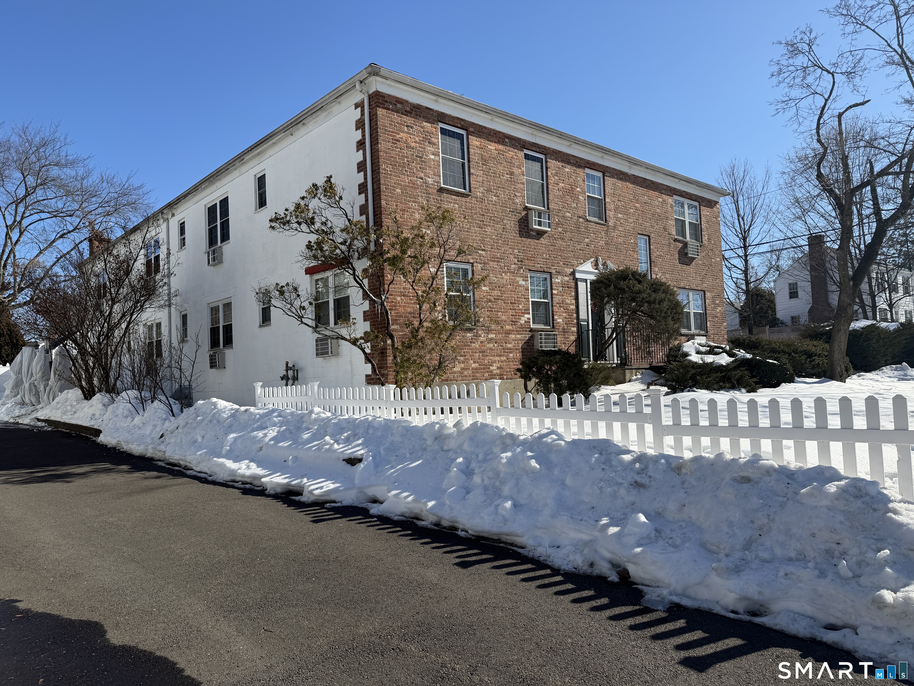 11 Belltown Road, Unit 1 Stamford, CT 06905 - Photo 2 of 10 a front view of a house with a yard