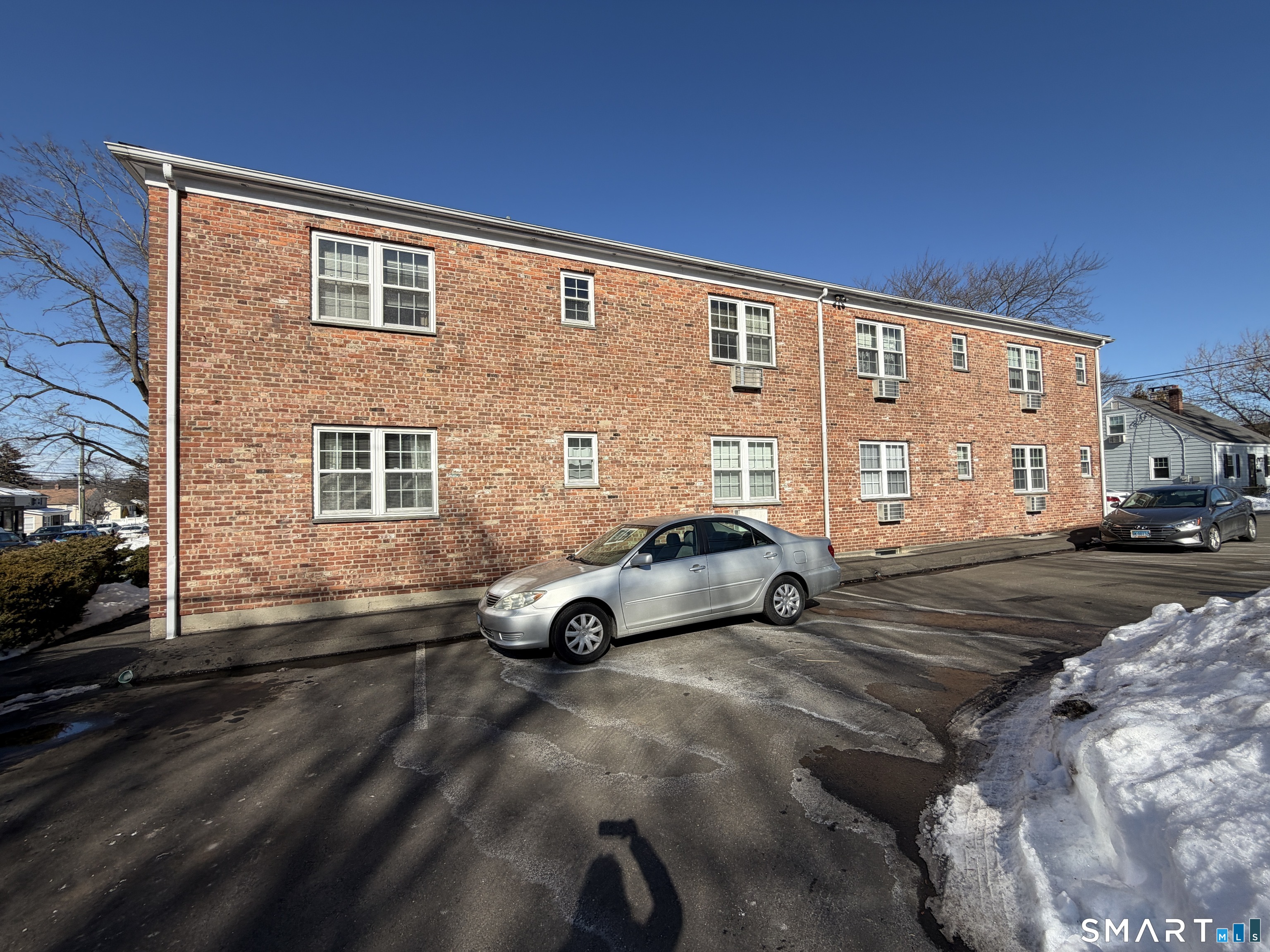 11 Belltown Road, Unit 1 Stamford, CT 06905 - Photo 5 of 10 a view of parking with double door