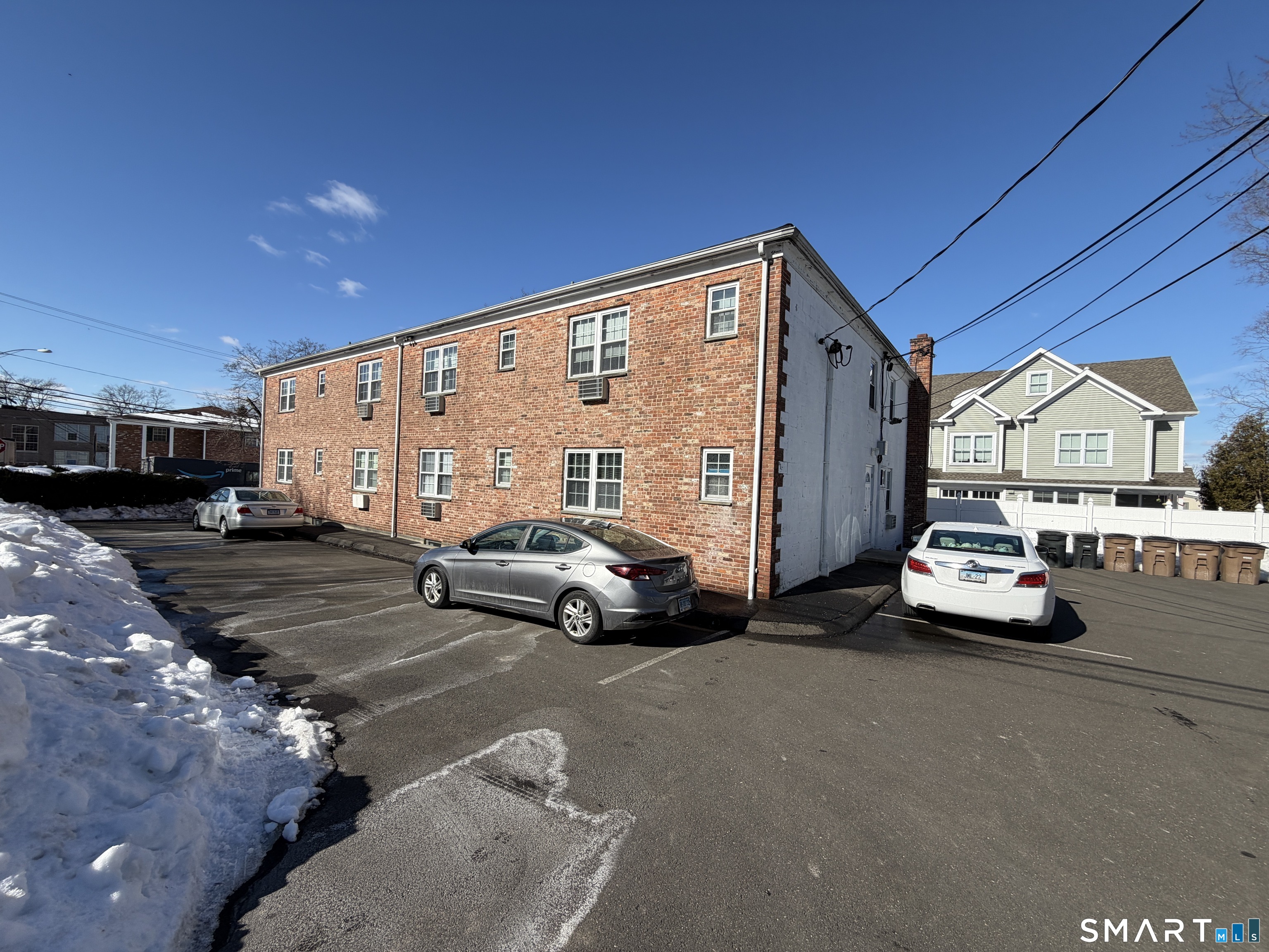 11 Belltown Road, Unit 1 Stamford, CT 06905 - Photo 6 of 10 a view of a cars park in front of house