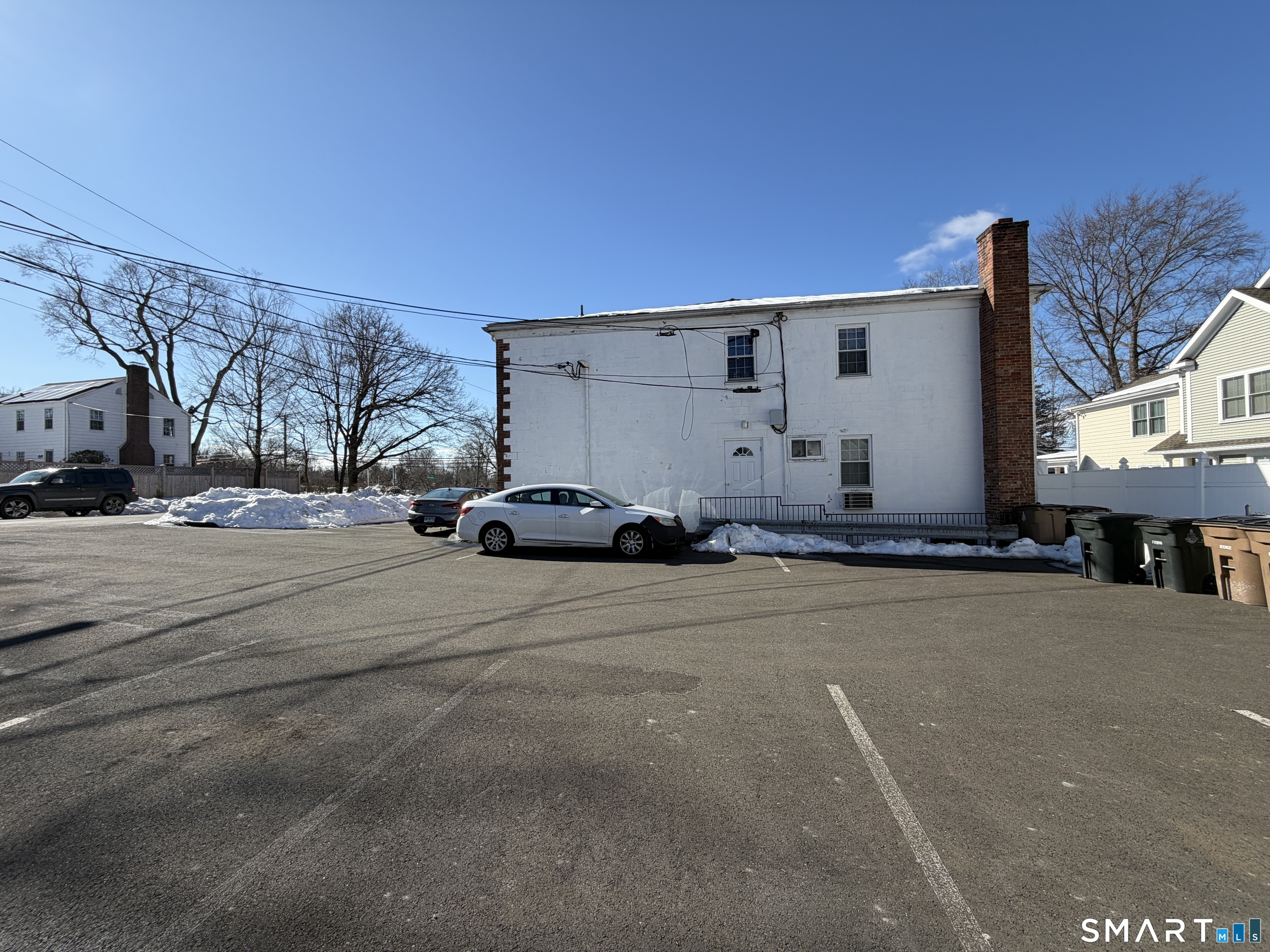 11 Belltown Road, Unit 1 Stamford, CT 06905 - Photo 8 of 10 a front view of a building with cars parked