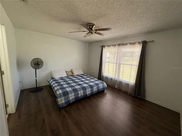 a living room with hard wood floors and a window