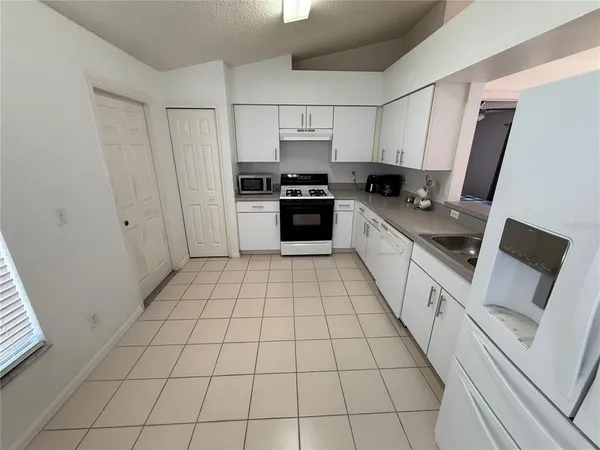 a kitchen with a stove a sink and a refrigerator
