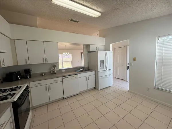 a kitchen with a sink cabinets and appliances