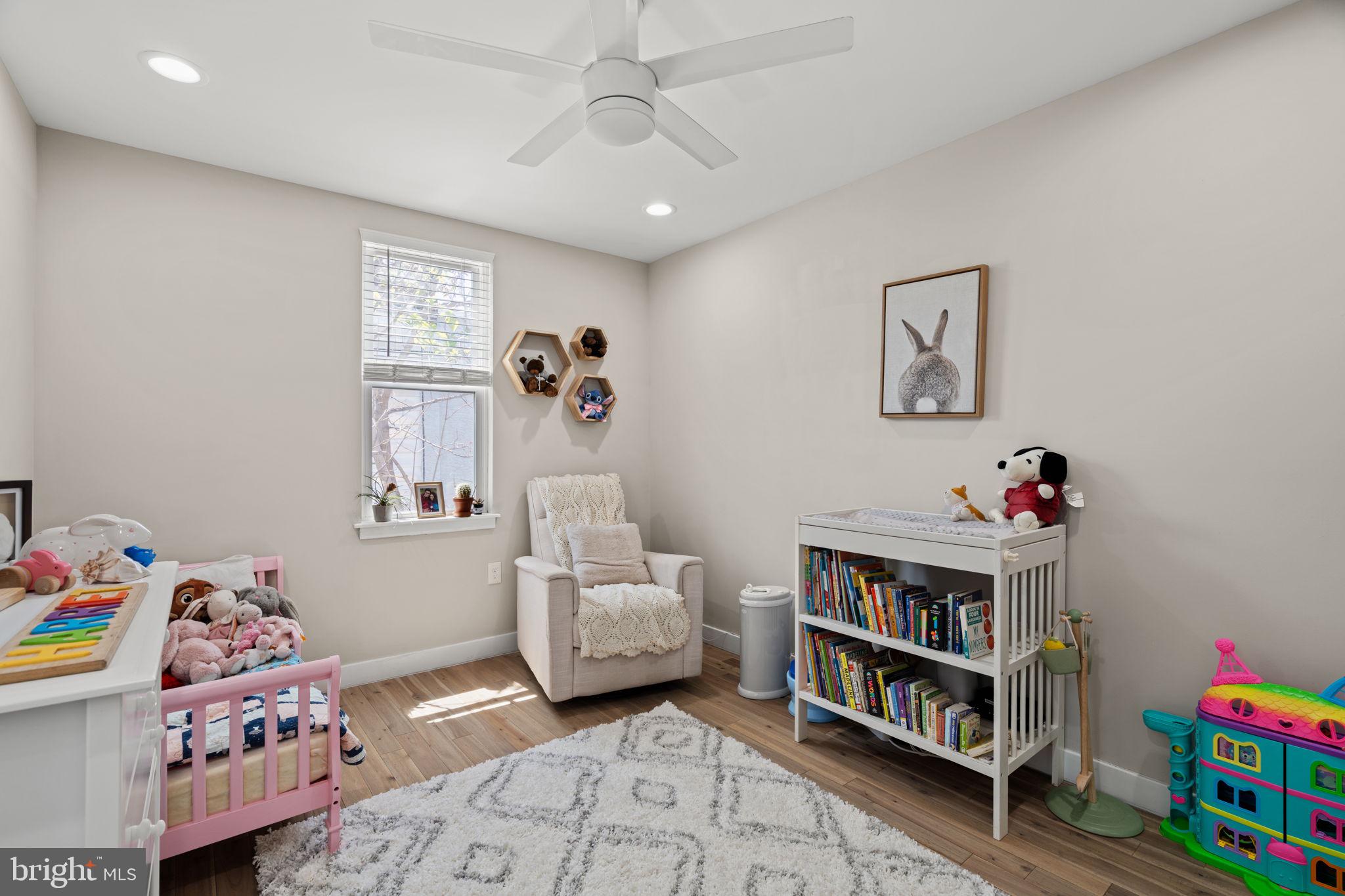 2934 Nicholas Street Philadelphia, PA 19121 - Photo 18 of 33 a room with furniture a baby crib and a book shelf
