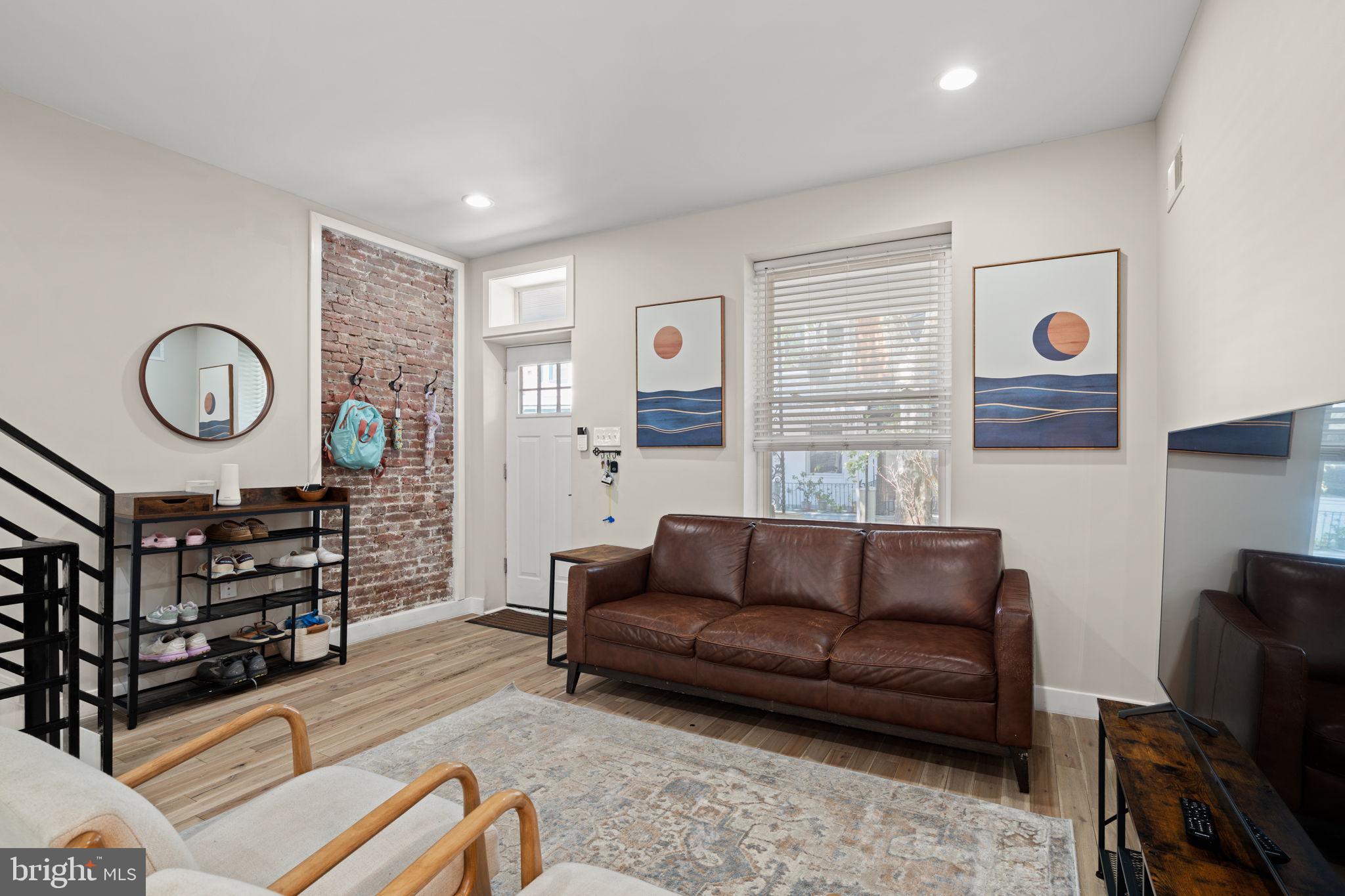 2934 Nicholas Street Philadelphia, PA 19121 - Photo 2 of 33 a living room with furniture a window and a clock