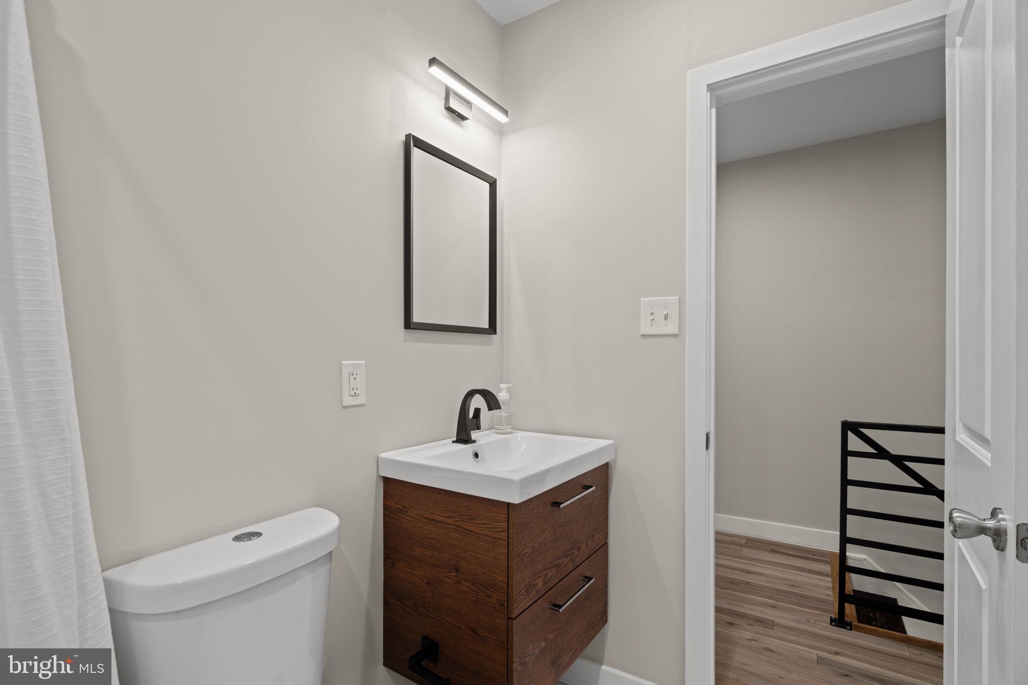 2934 Nicholas Street Philadelphia, PA 19121 - Photo 21 of 33 a bathroom with a toilet sink and mirror