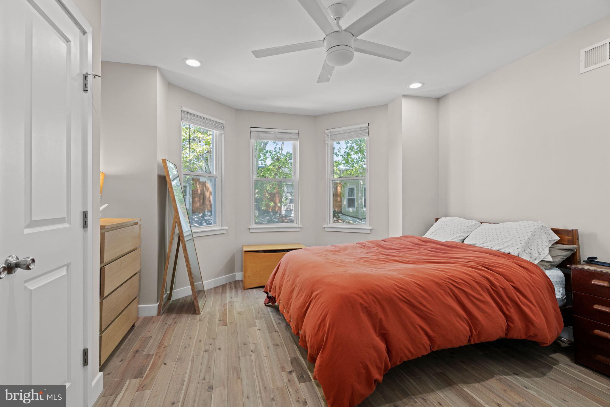 2934 Nicholas Street Philadelphia, PA 19121 - Photo 22 of 33 a bed sitting in a spacious bedroom next to a window