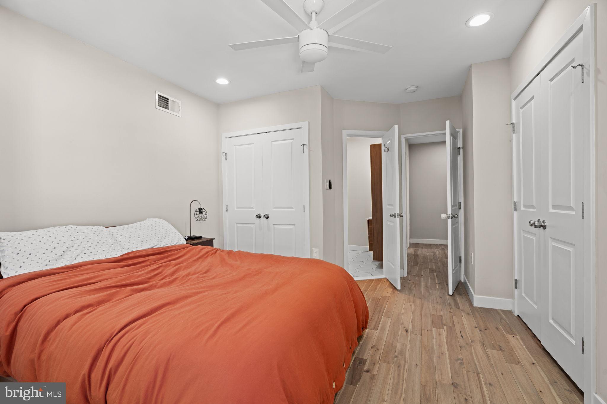 2934 Nicholas Street Philadelphia, PA 19121 - Photo 23 of 33 a spacious bedroom with a bed and a wooden floor