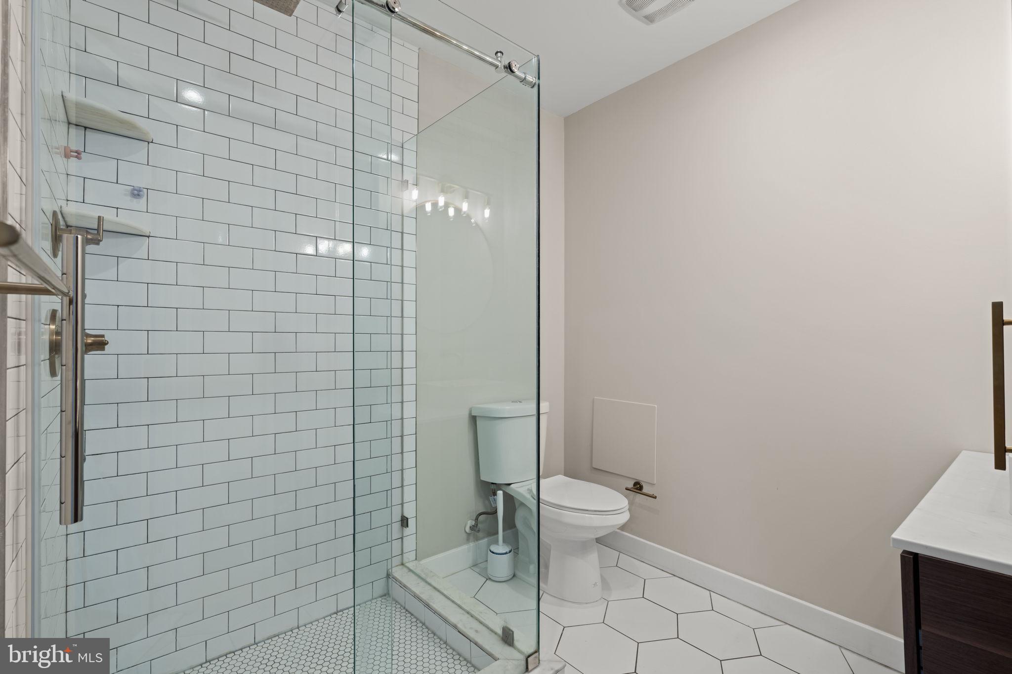 2934 Nicholas Street Philadelphia, PA 19121 - Photo 25 of 33 a bathroom with a toilet and a shower