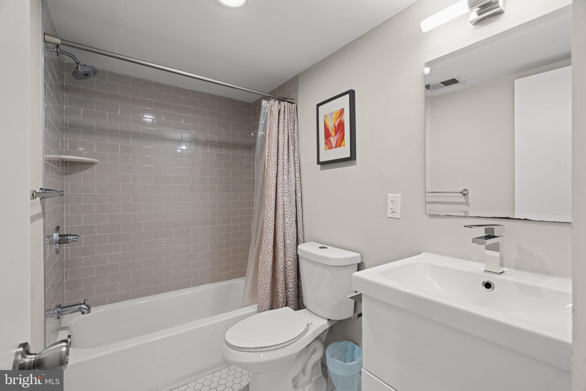 2934 Nicholas Street Philadelphia, PA 19121 - Photo 32 of 33 a bathroom with a toilet sink and shower