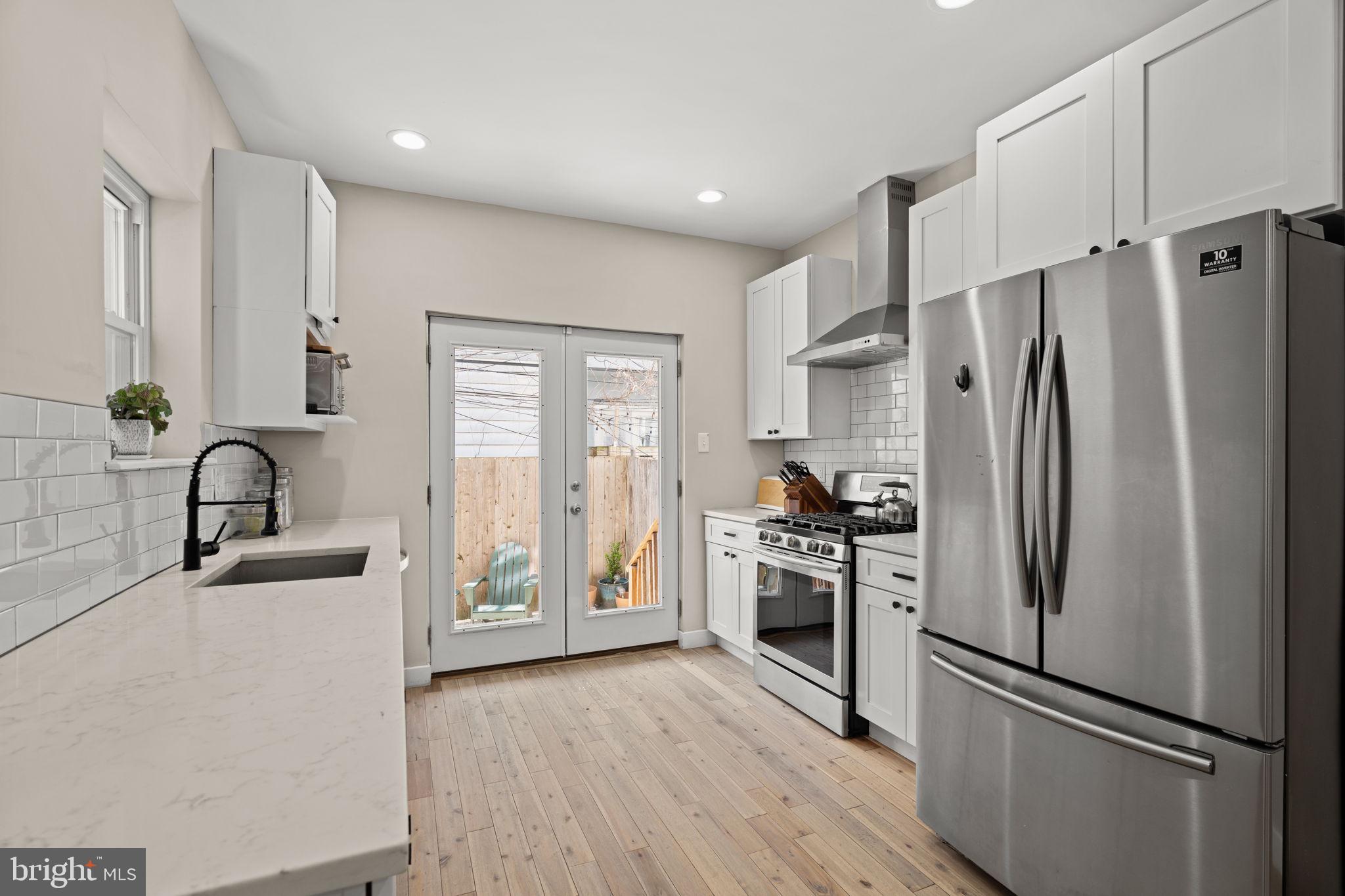 2934 Nicholas Street Philadelphia, PA 19121 - Photo 8 of 33 a kitchen with stainless steel appliances a refrigerator sink and stove