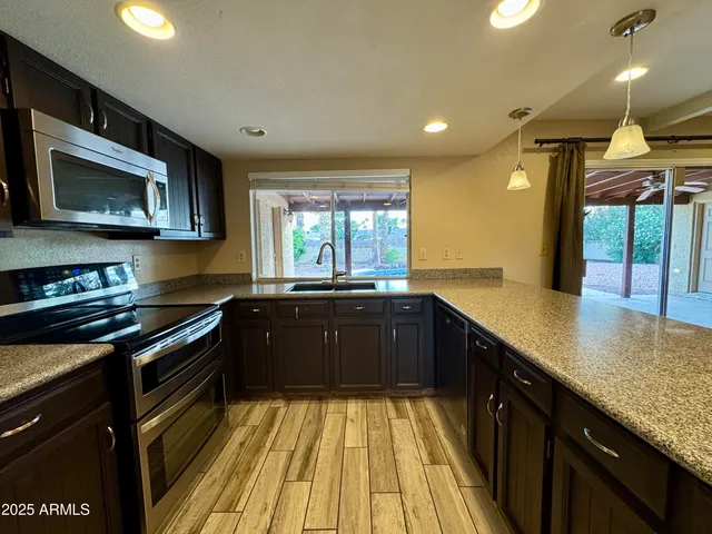 a kitchen with a sink stove and microwave