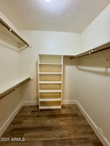 a view of walk in closet with empty racks