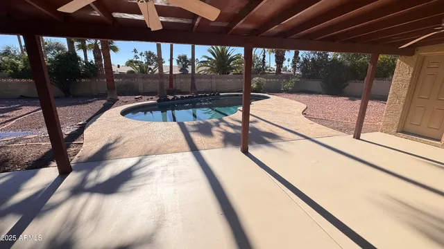 a view of swimming pool with a patio