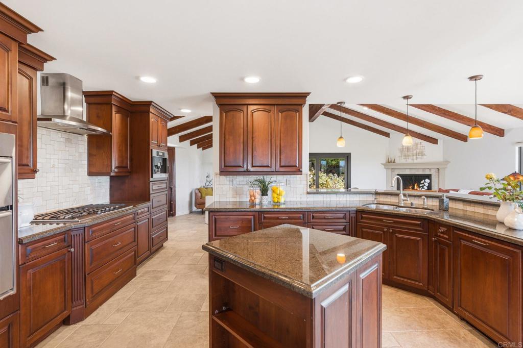 13319 Pacer Lane Poway, CA 92064 - Photo 11 of 75 a kitchen with stainless steel appliances granite countertop a sink and a stove