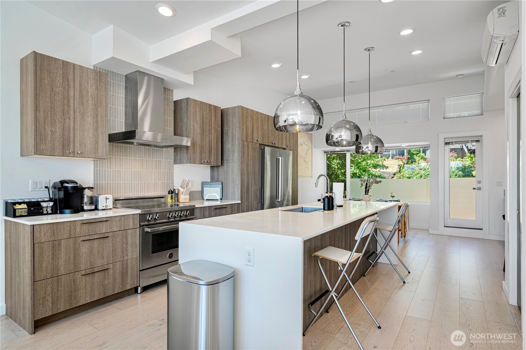 1546 Sturgus Avenue South Seattle, WA 98144 - Photo 11 of 23 a kitchen with stainless steel appliances kitchen island a table chairs in it and wooden floors