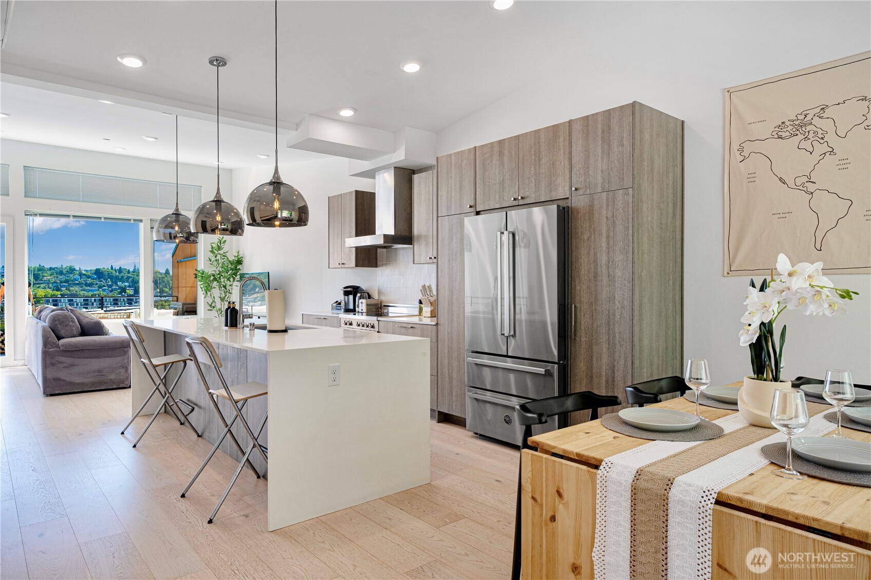 1546 Sturgus Avenue South Seattle, WA 98144 - Photo 13 of 23 a kitchen with a refrigerator a stove a sink a dining table and chairs with wooden floor