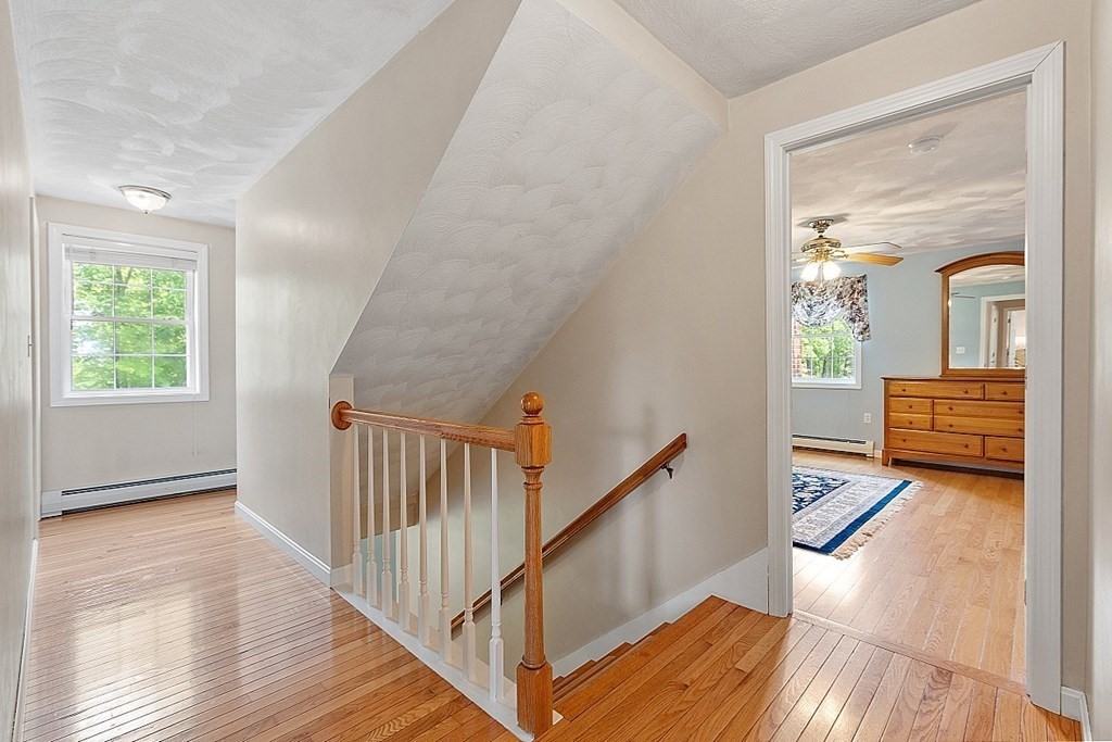 54 Little Turnpike Road Shirley, MA 01464 - Photo 21 of 39 a view of a hallway view with wooden floor and staircase