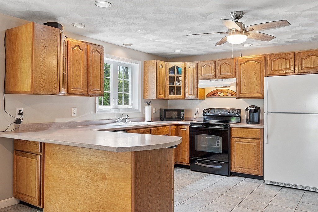 54 Little Turnpike Road Shirley, MA 01464 - Photo 6 of 39 a kitchen with stainless steel appliances granite countertop a sink stove and refrigerator
