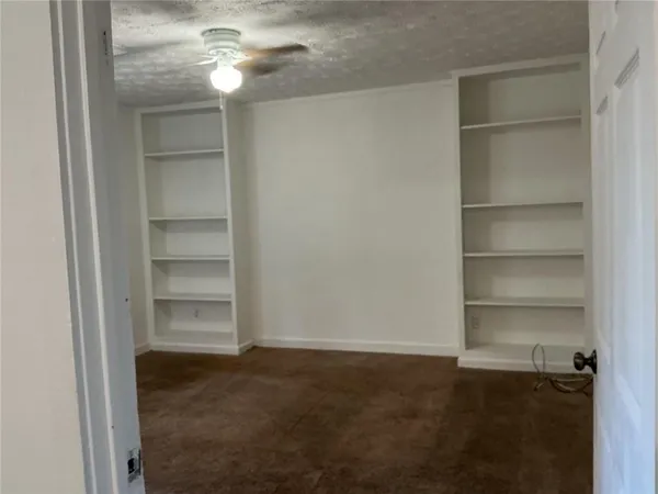 a view of an empty room with a closet