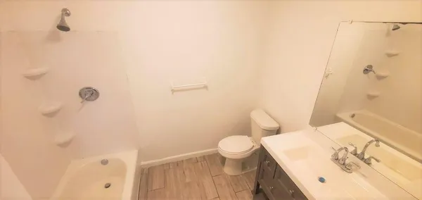 a bathroom with a sink toilet and mirror