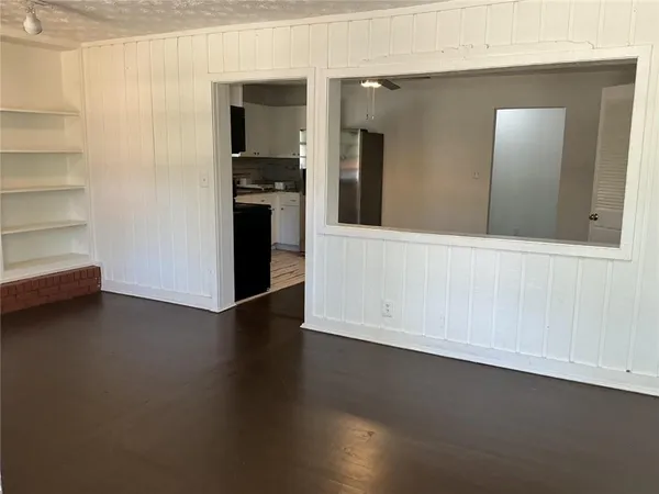 en empty room with wooden floor and closet