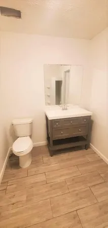 a view of a house with a backyard and a tree