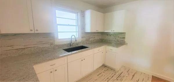 a kitchen with a sink and cabinets