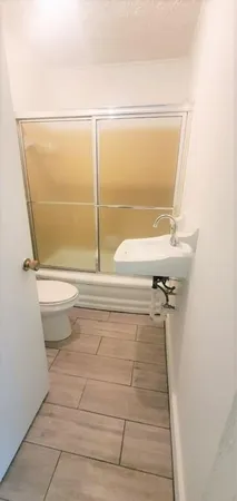 a bathroom with a toilet and a shower