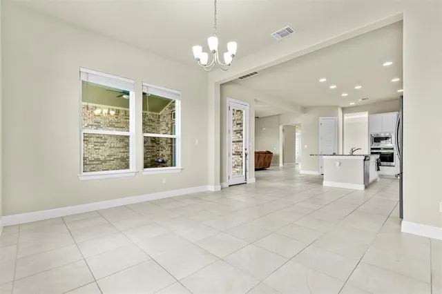 a view of an empty room with a kitchen