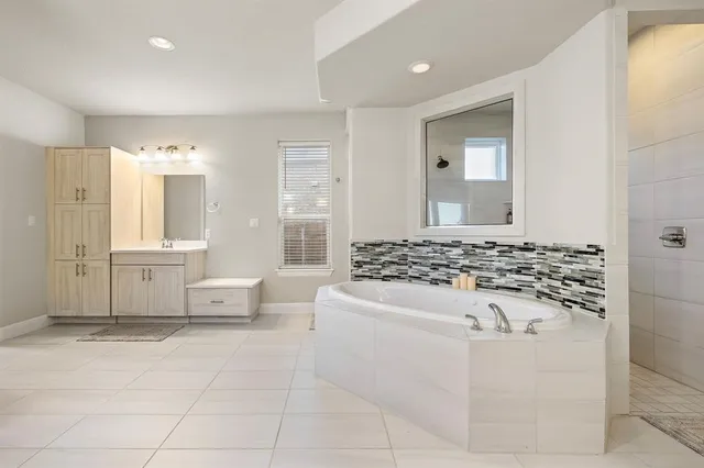 a bathroom with a sink a mirror and a bathtub