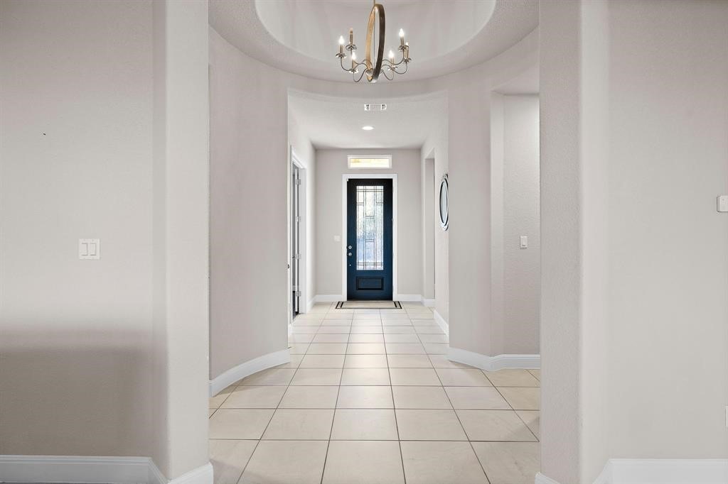 111 Tabago Court Austin, TX 78737 - Photo 2 of 22 a view of a hallway with a chandelier fan and windows