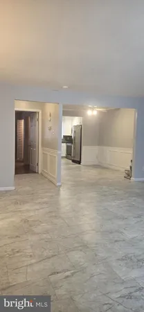 a view of a hallway with a kitchen