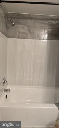 a bathroom with a shower and a tub