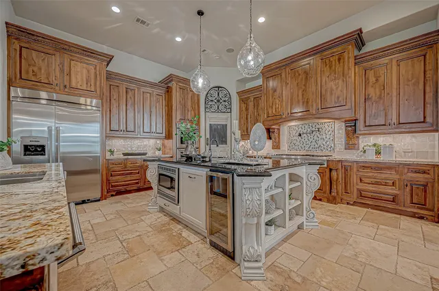a kitchen with stainless steel appliances granite countertop a stove and a sink