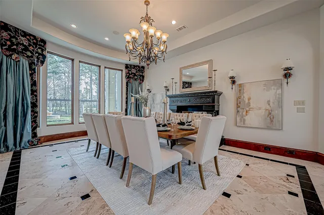 a view of a dining room with furniture a chandelier and wooden floor