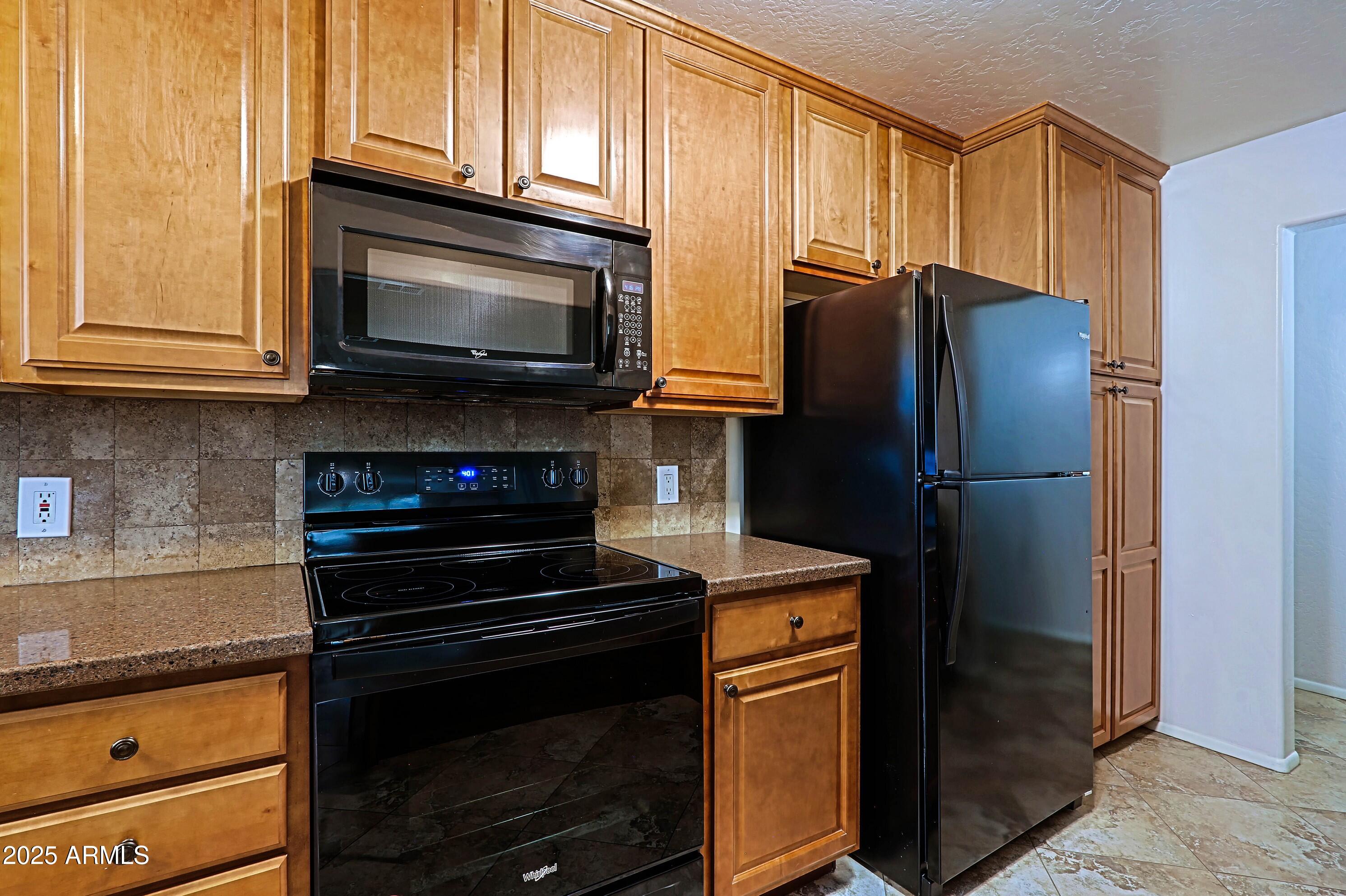 5509 East Cheery Lynn Road, Unit 2E Phoenix, AZ 85018 - Photo 13 of 25 a kitchen with a refrigerator stove and cabinets