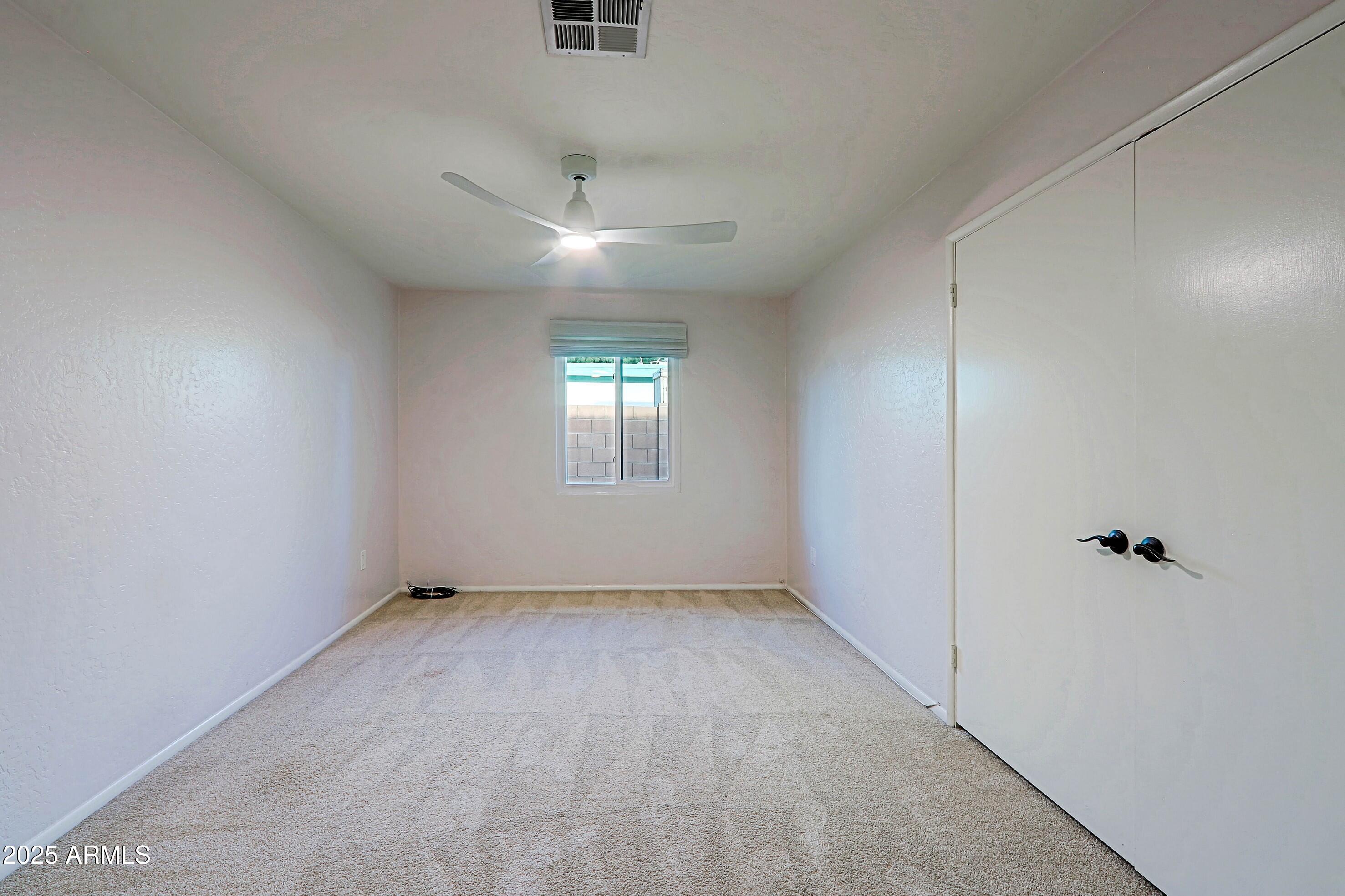 5509 East Cheery Lynn Road, Unit 2E Phoenix, AZ 85018 - Photo 17 of 25 wooden floor in an empty room with a window