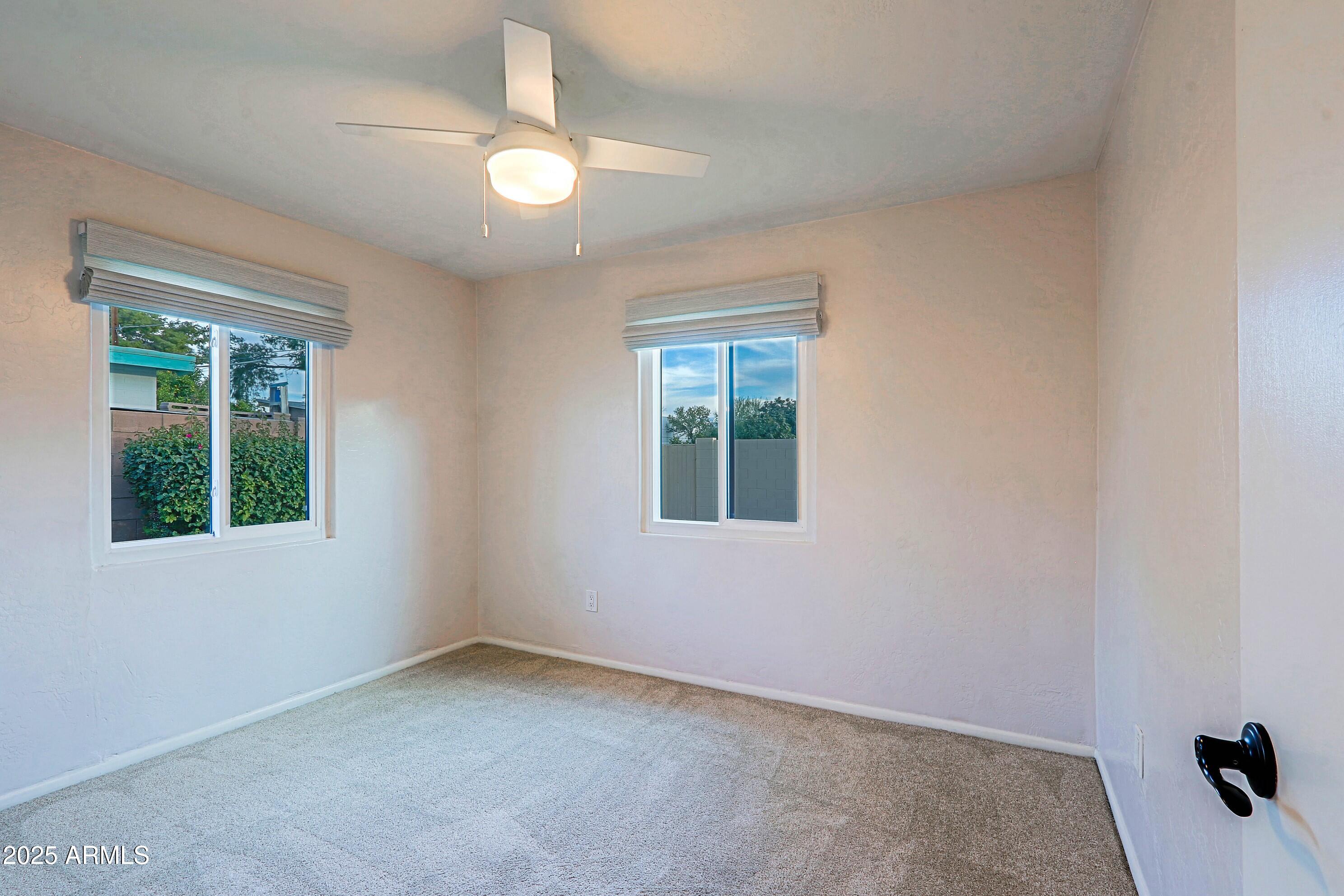 5509 East Cheery Lynn Road, Unit 2E Phoenix, AZ 85018 - Photo 20 of 25 an empty room with a window