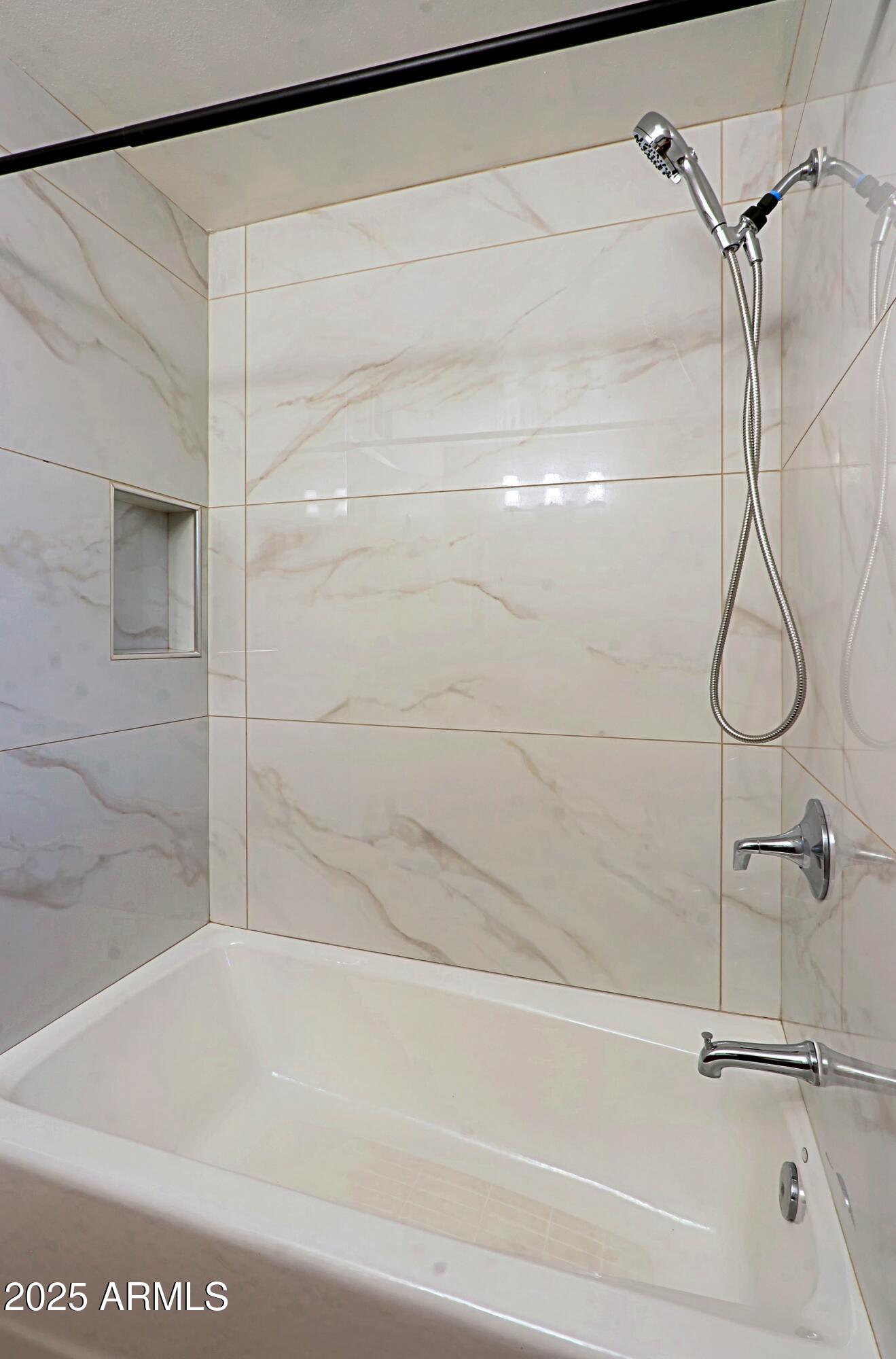 5509 East Cheery Lynn Road, Unit 2E Phoenix, AZ 85018 - Photo 23 of 25 a bathroom with a shower and a bath tub
