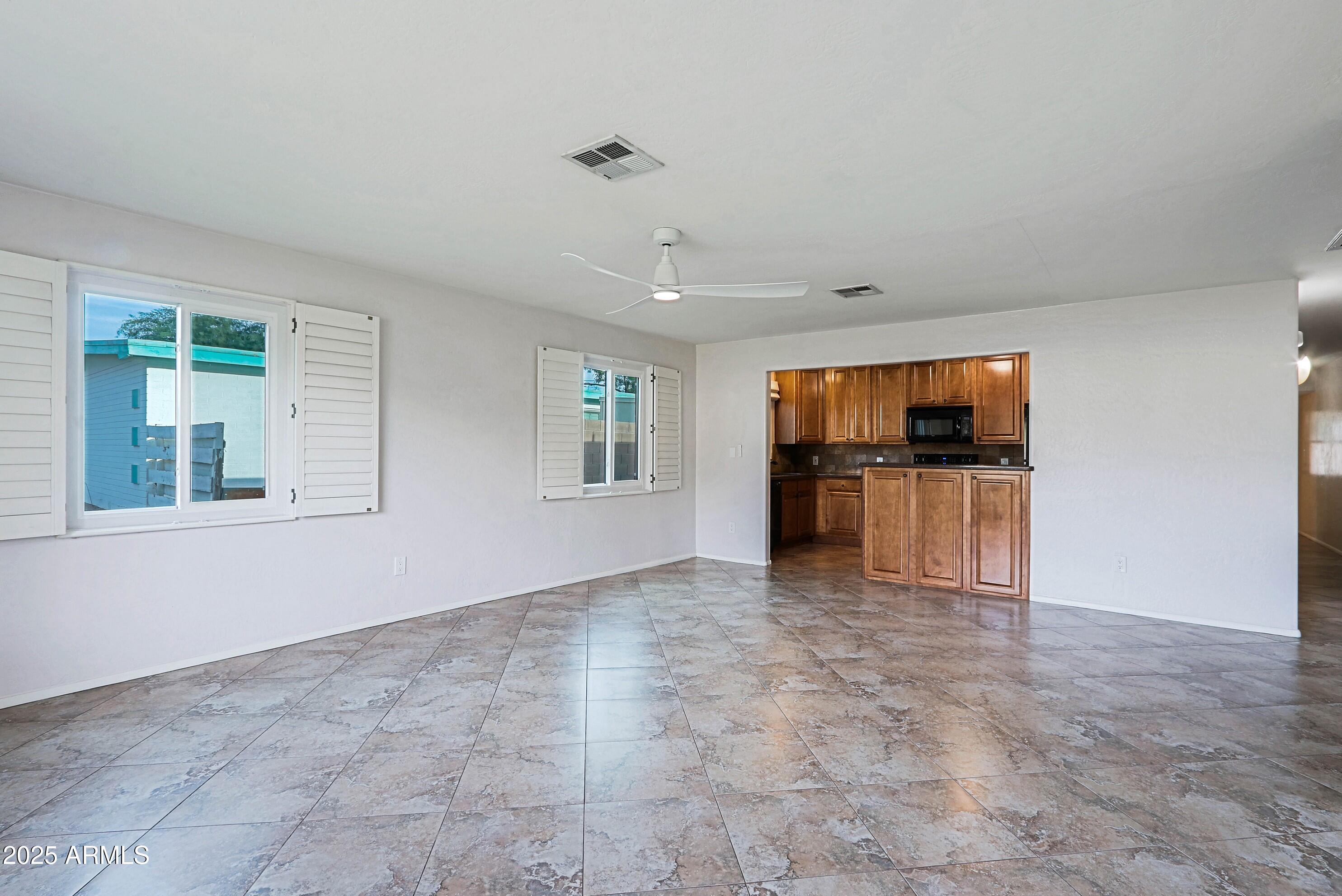 5509 East Cheery Lynn Road, Unit 2E Phoenix, AZ 85018 - Photo 8 of 25 a view of empty room with kitchen and window