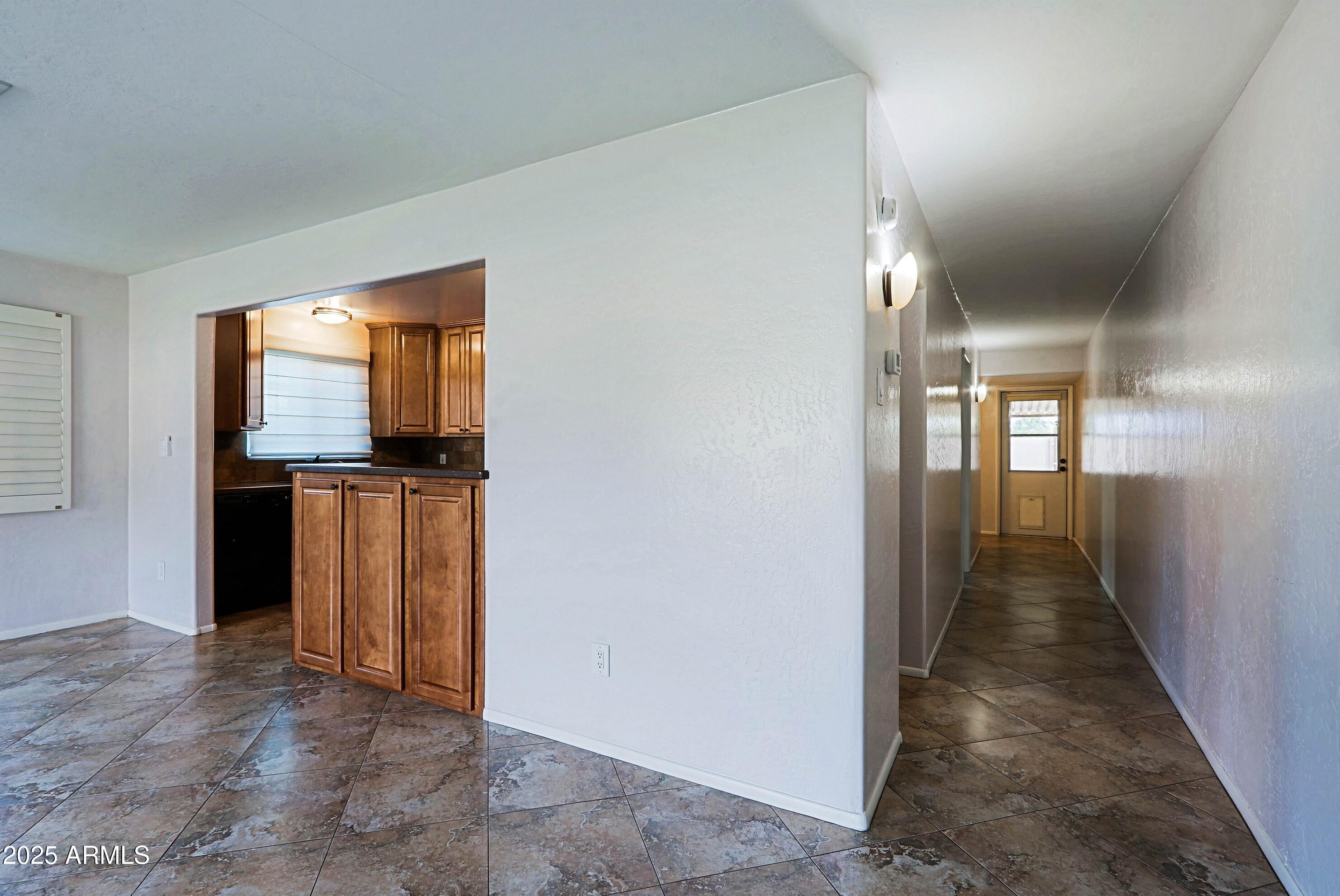 5509 East Cheery Lynn Road, Unit 2E Phoenix, AZ 85018 - Photo 10 of 25 a view of a hallway with wooden floor and windows