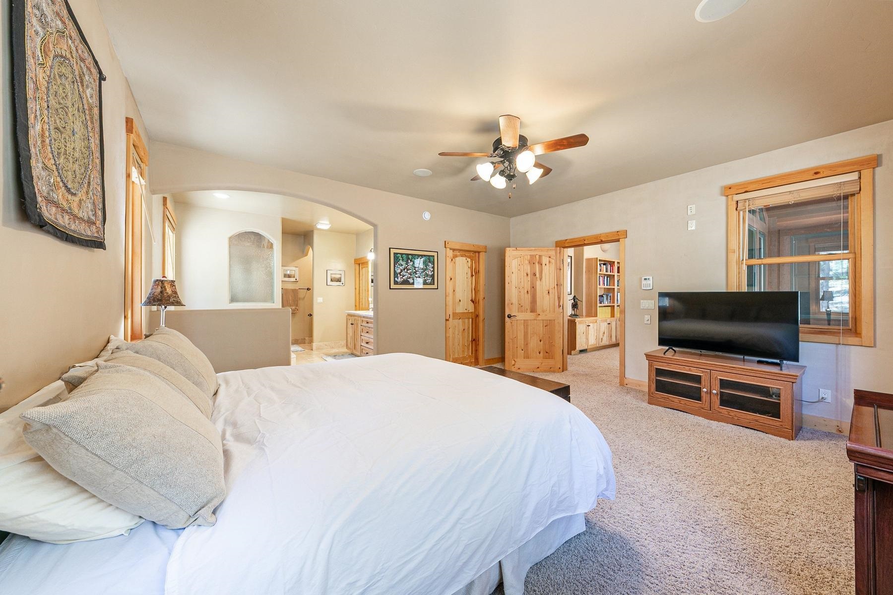 14070 Alder Creek Road Truckee, CA 96161 - Photo 10 of 28 a spacious bedroom with a bed and a flat screen tv
