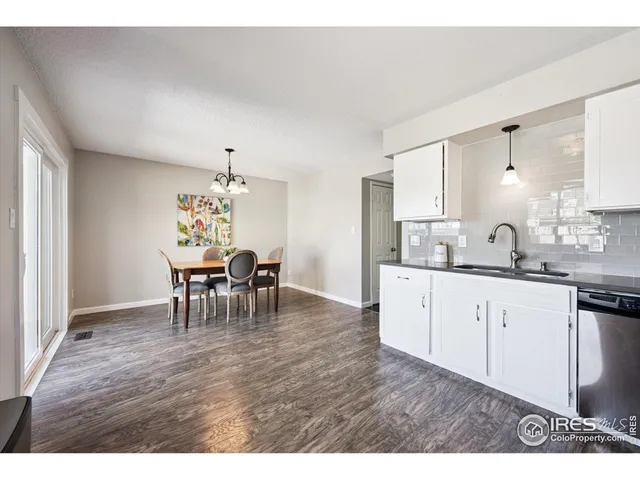 a kitchen with dining table and chairs