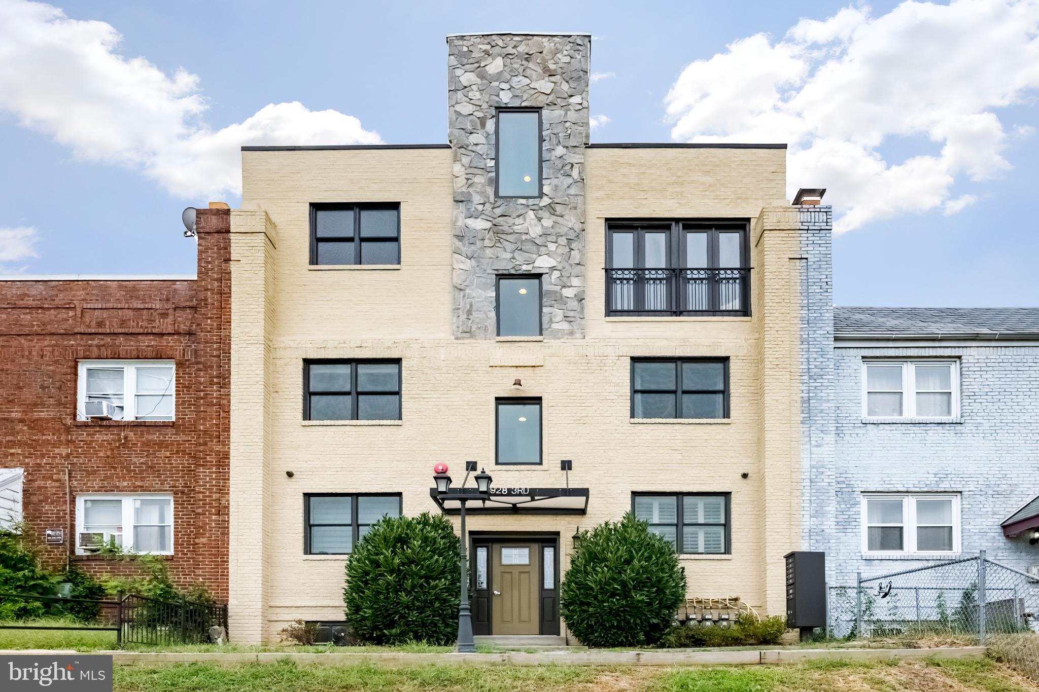 a front view of residential houses with yard