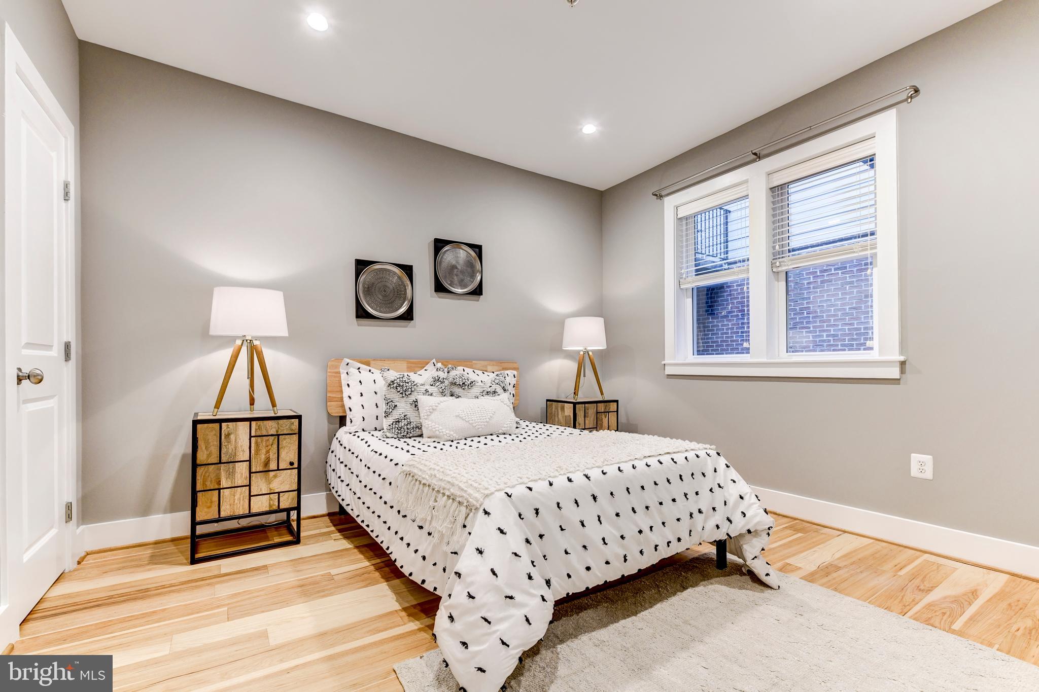 1928 3rd Street Northeast, Unit 2 Washington, DC 20002 - Photo 12 of 20 a bedroom with a bed and a window