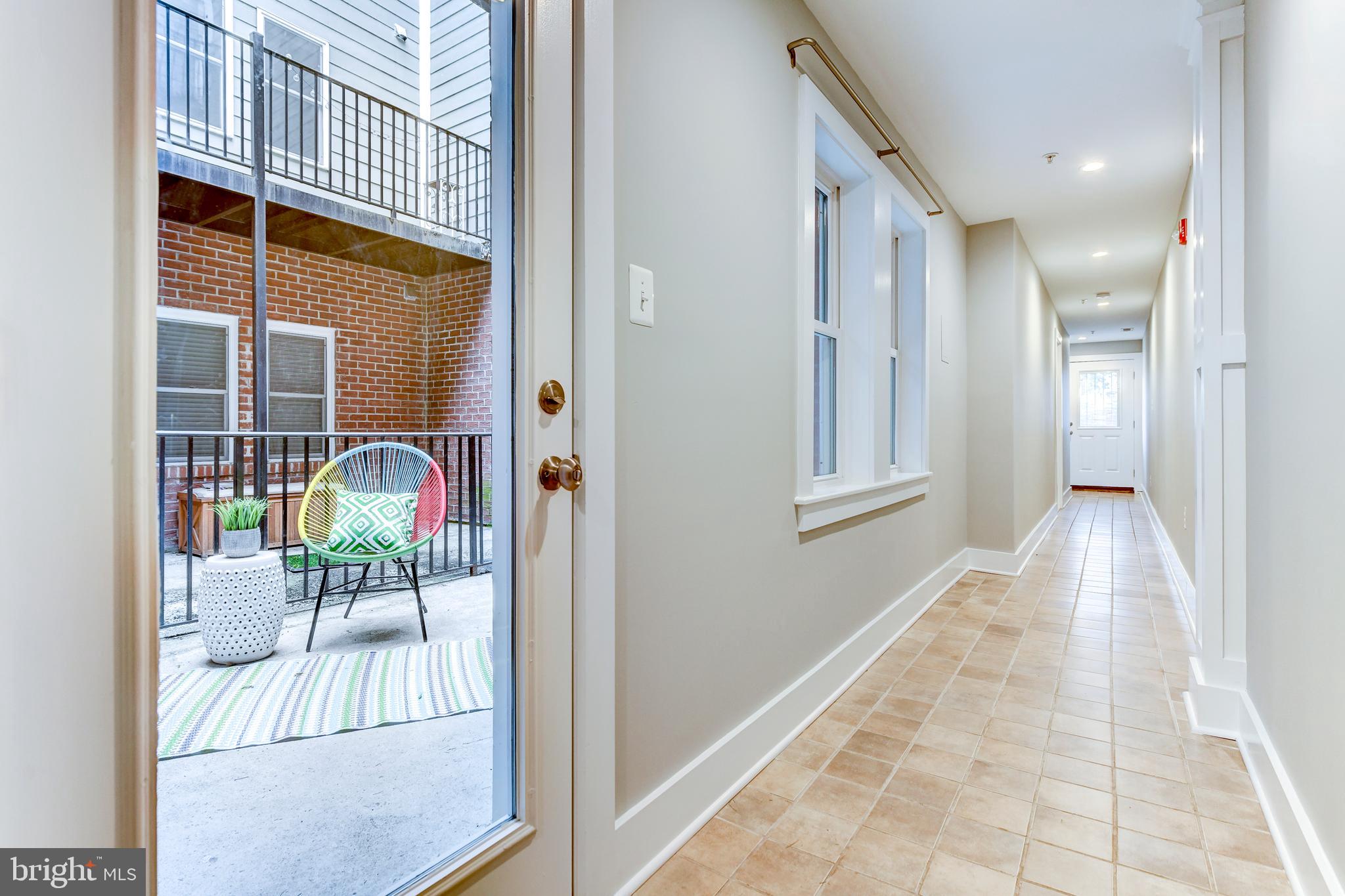 1928 3rd Street Northeast, Unit 2 Washington, DC 20002 - Photo 17 of 20 a view of a hallway with wooden floor and dining room