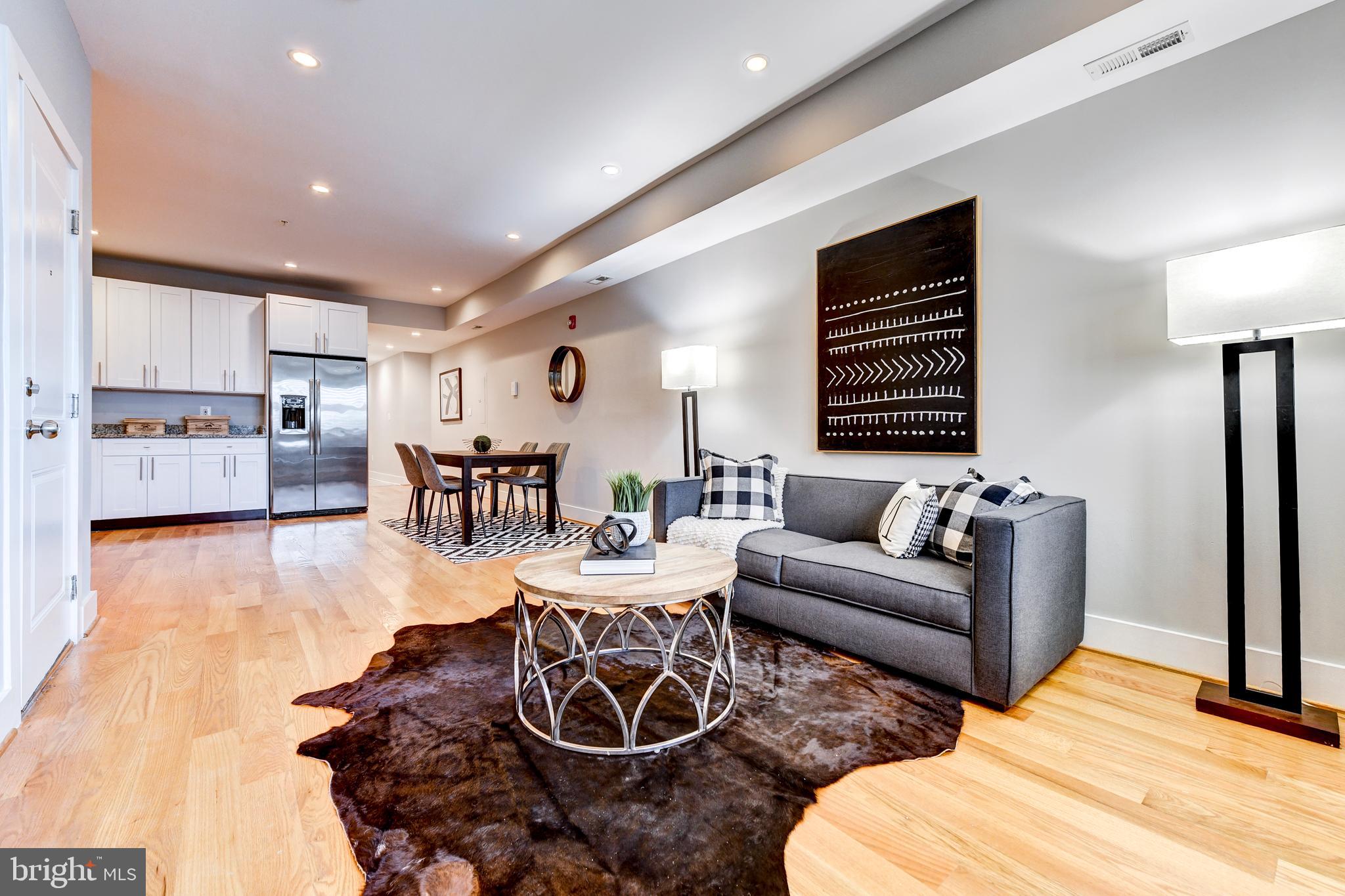 1928 3rd Street Northeast, Unit 2 Washington, DC 20002 - Photo 3 of 20 a living room with furniture and wooden floor