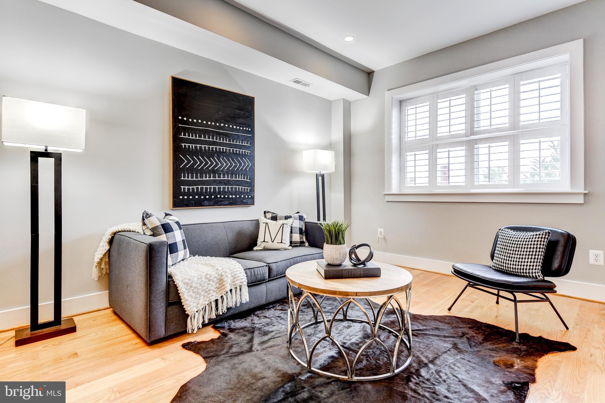 1928 3rd Street Northeast, Unit 2 Washington, DC 20002 - Photo 4 of 20 a living room with furniture a lamp and a window