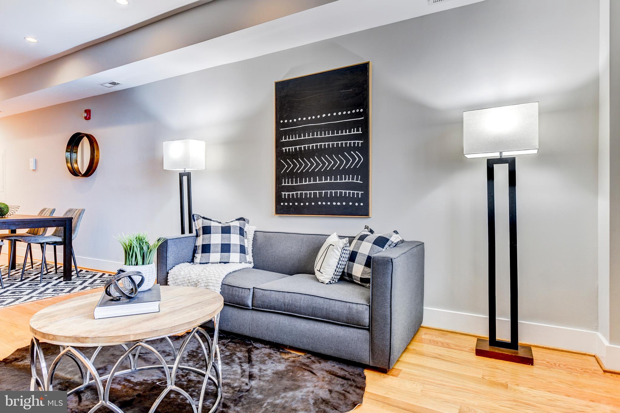 1928 3rd Street Northeast, Unit 2 Washington, DC 20002 - Photo 6 of 20 a living room with furniture a lamp and a table